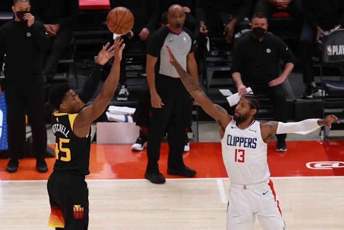 Donovan Mitchell (45) shoots a three pointer over Paul George (13)